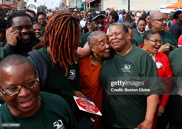 Kevin Peterson, left, of the New Democracy Coalition; and UMass student Vonds Dubuisson, second from left, smile as Gloria Patterson, center, of...