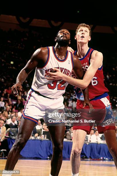 Herb Williams of the New York Knicks boxes out against Shawn Bradley of the Philadelphia 76ers on November 9, 1993 at Madison Square Garden in New...