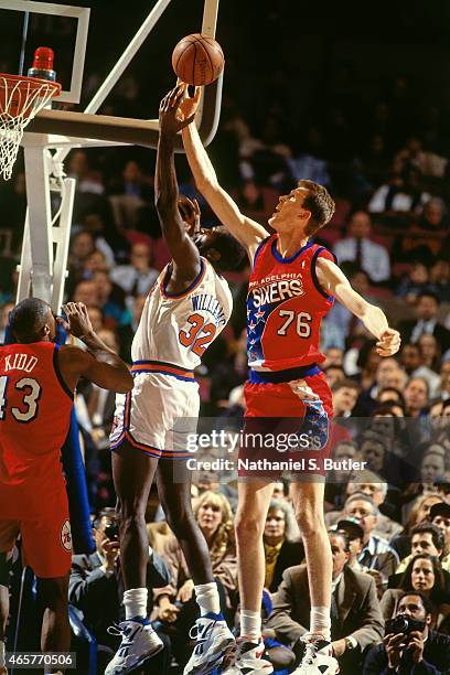 Shawn Bradley of the Philadelphia 76ers blocks a shot against Herb Williams of the New York Knicks on November 9, 1993 at Madison Square Garden in...