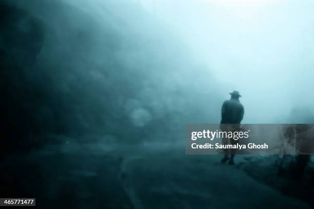 This shot is taken on the way from Munnar hill station to Thekkady in Kerala. While going through a dense cloud on a hill top, I found this man,...