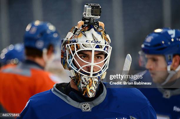 Kevin Poulin of the New York Islanders skates with a GoPro camera on his helmet during the 2014 NHL Stadium Series practice session at Yankee Stadium...