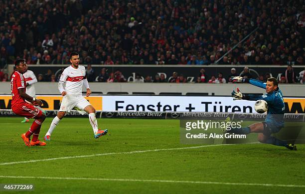 Vedad Ibisevic of Stuttgart scores his team's first goal against David Alaba and goalkeeper Manuel Neuer of Muenchen during the Bundesliga match...