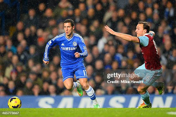 Eden Hazard of Chelsea turns away from Mark Noble of West Ham during the Barclays Premier League match between Chelsea and West Ham United at...