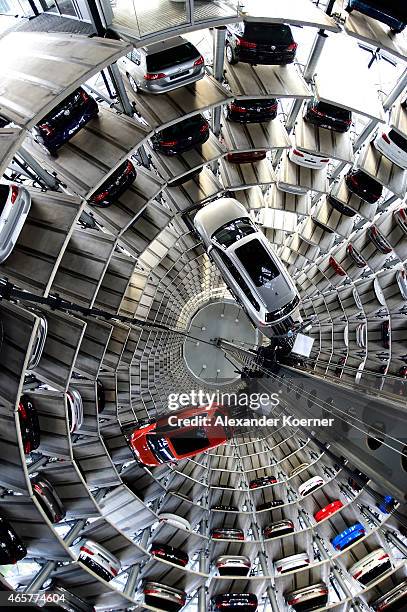 Brand new Volkswagen Passat and a Golf 7 car are stored in a tower at the Volkswagen Autostadt complex near the Volkswagen factory on March 10, 2015...