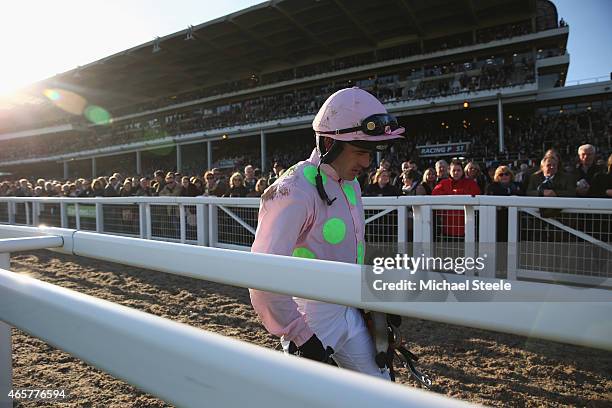 Ruby Walsh walks back along the main grandstand after falling at the last riding Annie Power during the Olbg Mares' Hurdle Race on day one at...