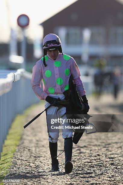 Ruby Walsh walks back along the main grandstand after falling at the last riding Annie Power during the Olbg Mares' Hurdle Race on day one at...