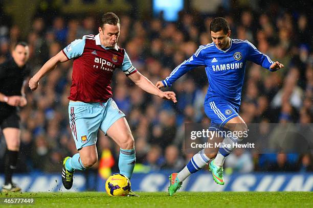 Eden Hazard of Chelsea marshalls Kevin Nolan of West Ham during the Barclays Premier League match between Chelsea and West Ham United at Stamford...