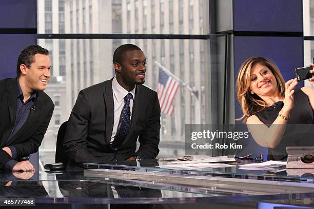Host Maria Bartiromo takes a selfie photo with football player Plaxico Burress and penny stock expert Timothy Sykes at "Opening Bell With Maria...