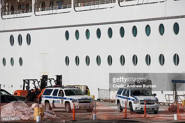 Port Authority police park outside the Royal Caribbean cruise ship "Explorer of the Sea" after it returned to port due to over 600 people became...