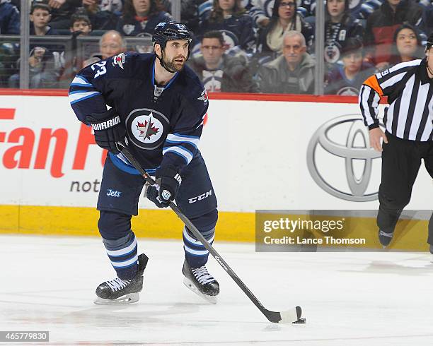 Jay Harrison of the Winnipeg Jets plays the puck down the ice during third period action against the Ottawa Senators on March 4, 2015 at the MTS...