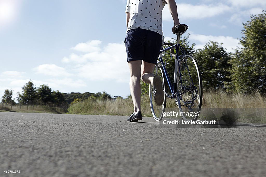 Male running with bicycle