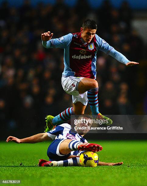 Ashley Westwood of Aston Villa leaps over the tackle of James Morrison of West Brom during the Barclays Premier League match between Aston Villa and...