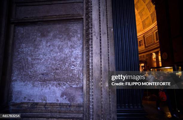 Names and initials are seen carved on a wall inside the Pantheon in Rome on March 9, 2015. Two American women caught carving their initials into a...