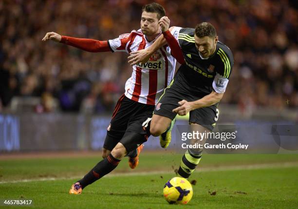 Ondrej Celustka of Sunderland is tackled by Erik Pieters of Stoke City during the Premier League match between Sunderland and Stoke City at Stadium...