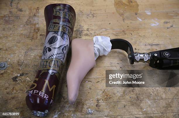 Custom leg socket to attach an artificial foot and a prosthetic leg, both for U.S. Military amputees, lie on a table at the Veterans Administration ,...