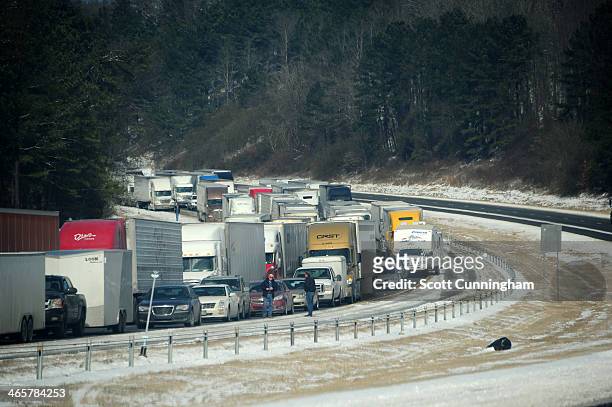 Vehicles sit in traffic along Interstate 75 in icy conditions January 29, 2014 in Atlanta, Georgia. Thousands of motorists were stranded, many...