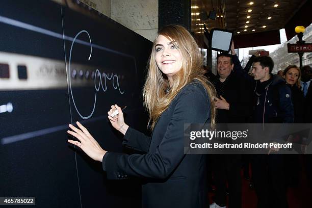 Cara Delevingne attends the Yves Saint Laurent Beauty event at Galeries Lafayette on March 10, 2015 in Paris, France.
