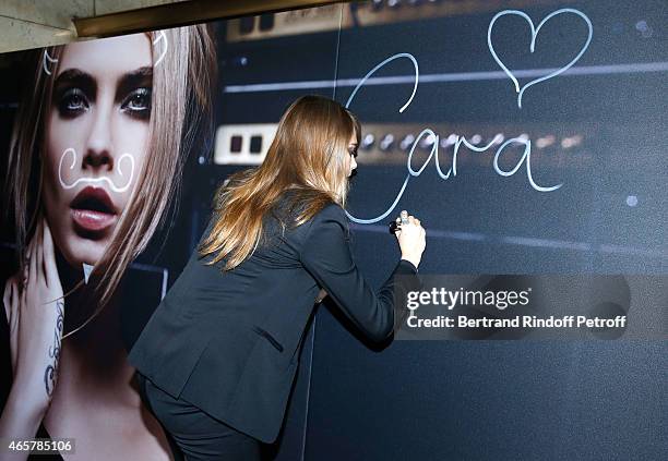 Cara Delevingne attends the Yves Saint Laurent Beauty event at Galeries Lafayette on March 10, 2015 in Paris, France.