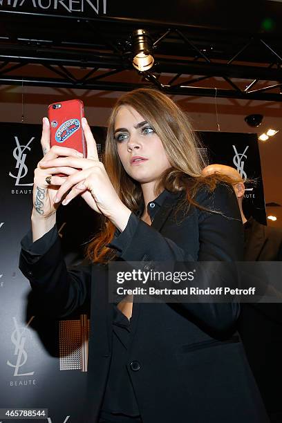 Cara Delevingne attends the Yves Saint Laurent Beauty event at Galeries Lafayette on March 10, 2015 in Paris, France.