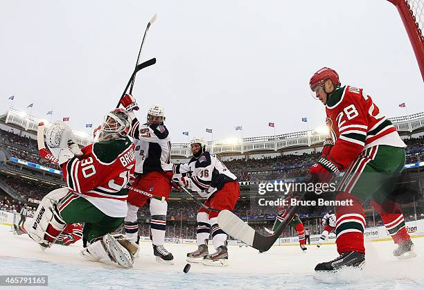 Anton Volchenkov and Martin Brodeur of the New Jersey Devils defend against Benoit Pouliot and Derick Brassard of the New York Rangers in the second...