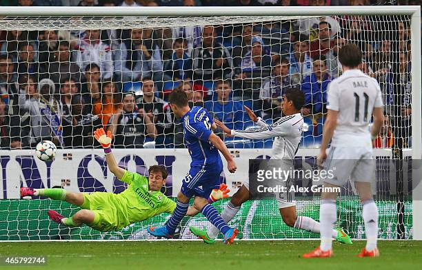 Klaas Jan Huntelaar of Schalke shoots past goalkeeper Iker Casillas of Real Madrid CF to score their second goal during the UEFA Champions League...