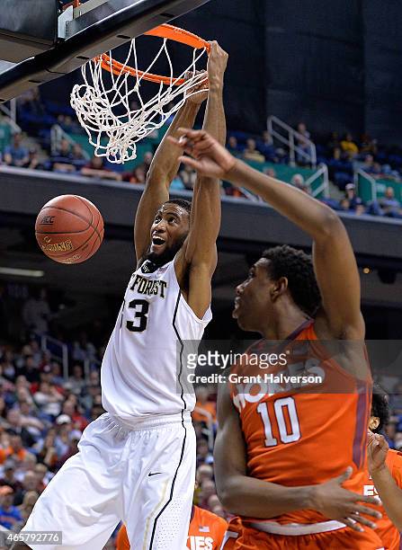 Aaron Rountree III of the Wake Forest Demon Deacons dunks over Justin Bibbs of the Virginia Tech Hokies during a first round game of the ACC...