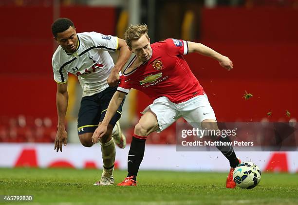 Andy Kellett of Manchester United U21s in action with Felip Lesniak of Tottenham Hotspur U21s during the Barclays U21 Premier League match between...