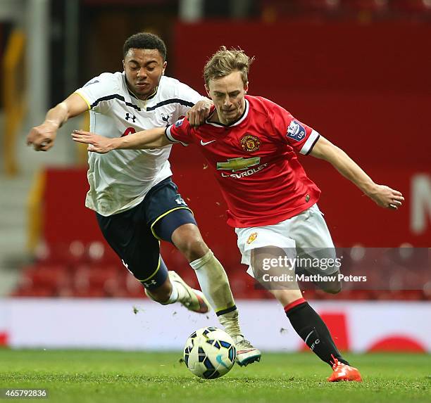 Andy Kellett of Manchester United U21s in action with Felip Lesniak of Tottenham Hotspur U21s during the Barclays U21 Premier League match between...