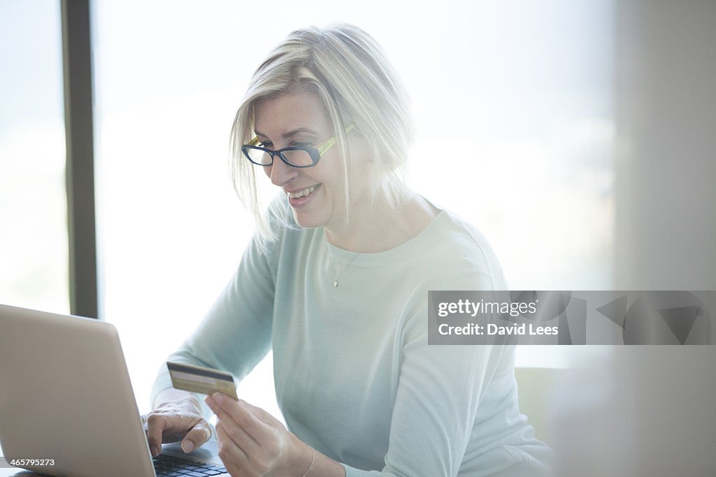 Woman shopping online with credit card