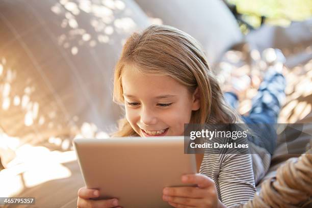 girl using digital tablet outdoors - child tablet stock pictures, royalty-free photos & images