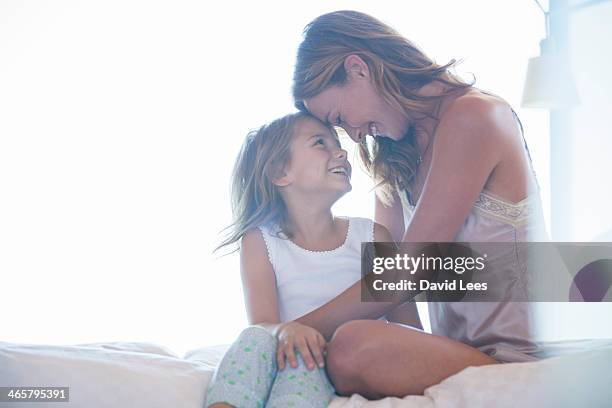 mother and daughter hugging on bed - kids in undies stock pictures, royalty-free photos & images