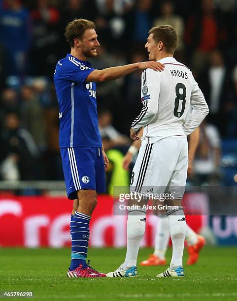 Captain Benedikt Hoewedes of Schalke and Toni Kroos of Real Madrid CF in discussion after the UEFA Champions League Round of 16 second leg match...