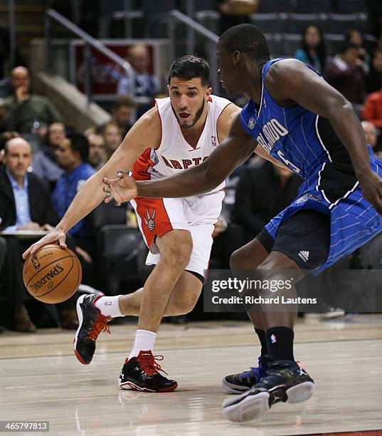 Toronto, ON - January 29 - In first half action, Toronto Raptors point guard Greivis Vasquez tries a move around Orlando Magic shooting guard Victor...