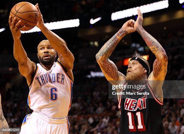 Guard Derek Fisher of the Oklahoma City Thunder passes the ball against Forward Chris Anderson of the Miami Heat at AmericanAirlines Arena on January...