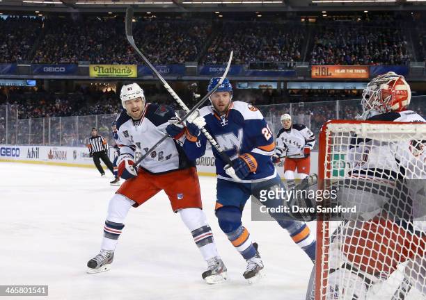 Rick Nash of the New York Rangers and Thomas Vanek of the New York Islanders vie for position in front of the Rangers net in the first period during...