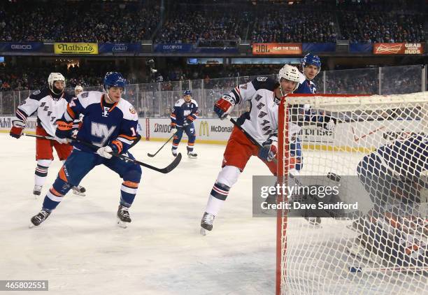 Benoit Pouliot of the New York Rangers scores in the second period as Thomas Hickey of the New York Islanders looks on during the 2014 Coors Light...