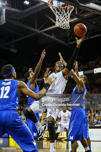 Central Florida's Isaiah Sykes goes up to the basket against Memphis' Shaq Goodwin during first-half action at the CFE Arena in Orlando, Fla. On...
