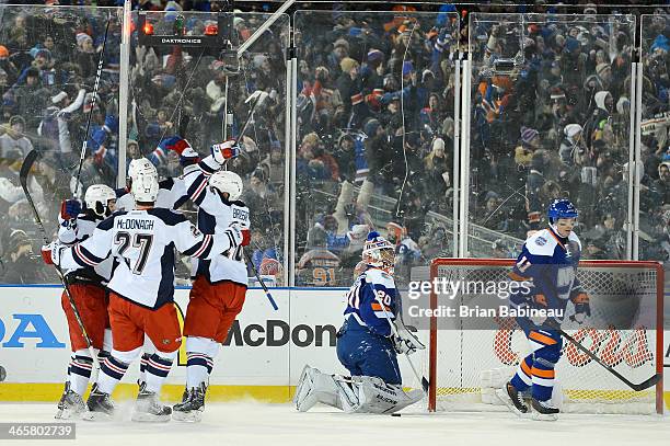 Benoit Pouliot of the New York Rangers celebrates with teammates after scoring against the New York Islanders in the second period to tie the game...