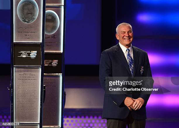 Hall of Fame inductee Dale Jarrett smiles as he listens to country music singer Blake Shelton's comments during the Hall of Fame induction ceremony...