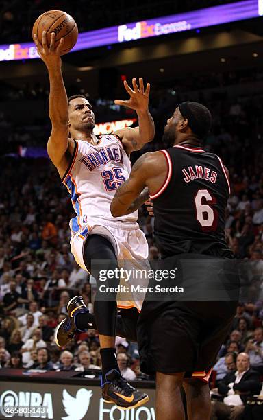 Guard Thabo Sefolosha of the Oklahoma City Thunder is defended by Forward LeBron James of the Miami Heat at AmericanAirlines Arena on January 29,...