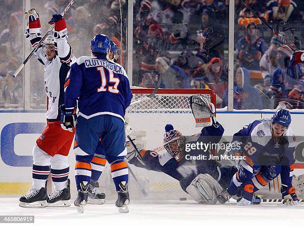Daniel Carcillo of the New York Rangers celebrates his game winning goal as the puck goes past Cal Clutterbuck and Evgeni Nabokov of the New York...