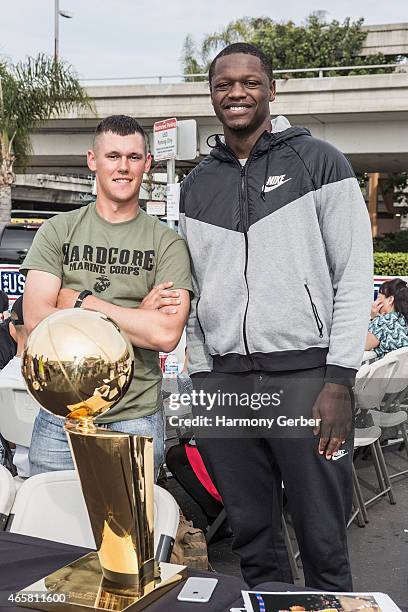 Los Angeles Laker Julius Randle autographs photos for U.S. Troops at the Bob Hope USO at LAX on March 10, 2015 in Los Angeles, California.