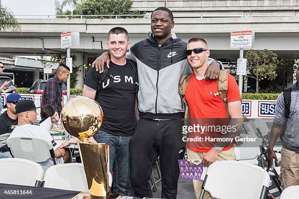 Los Angeles Laker Julius Randle autographs photos for U.S. Troops at the Bob Hope USO at LAX on March 10, 2015 in Los Angeles, California.