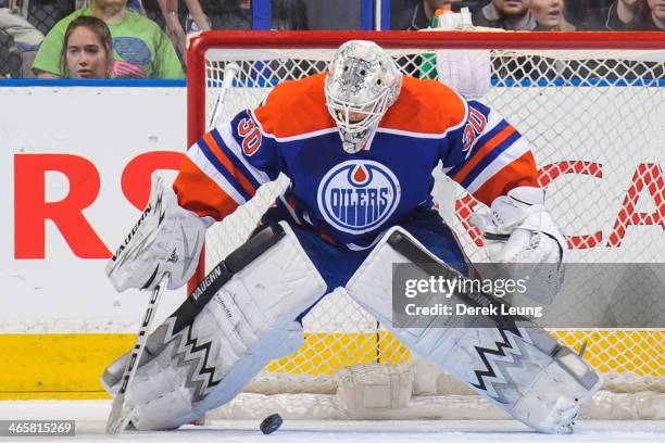 Ben Scrivens of the Edmonton Oilers eyes the loose puck and stops it against the San Jose Sharks during an NHL game at Rexall Place on January 29,...