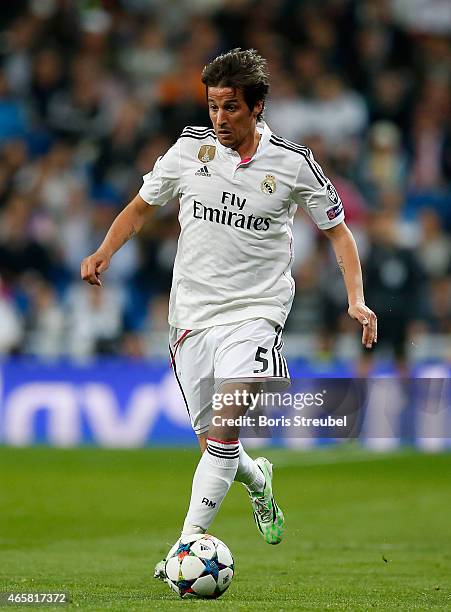 Fabio Coentrao of Real Madrid runs with the ball during the UEFA Champions League Round of 16 second leg match between Real Madrid CF and FC Schalke...