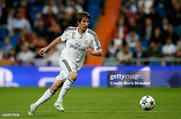 Fabio Coentrao of Real Madrid runs with the ball during the UEFA Champions League Round of 16 second leg match between Real Madrid CF and FC Schalke...