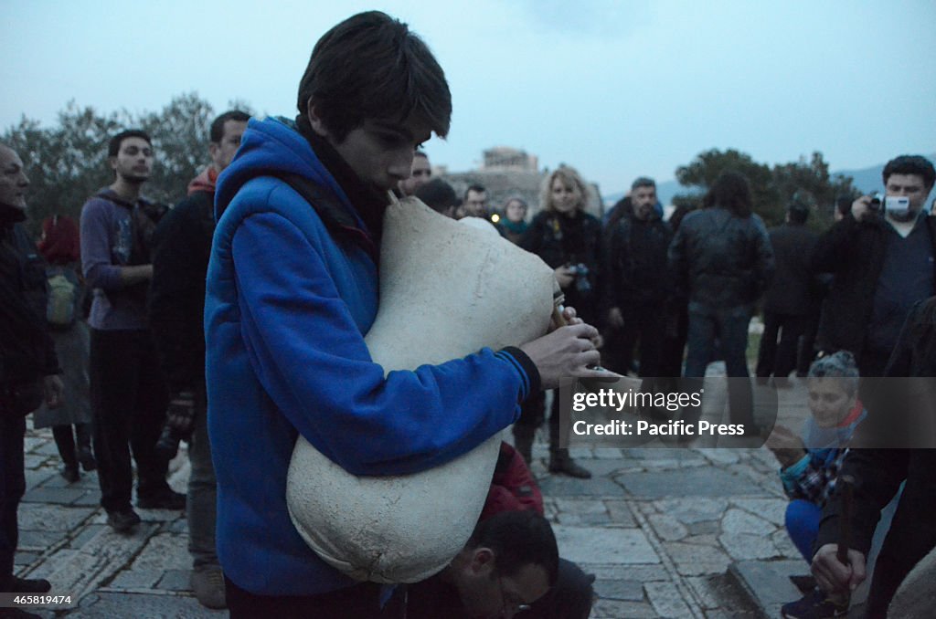 A young musician plays on top of FIlopapou hill oposite...