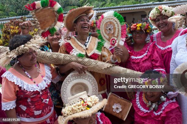 French Overseas Territories Minister George Pau-Langevin shares a light moment with residents on March 10, 2015 on the island of Tubuai, south of...