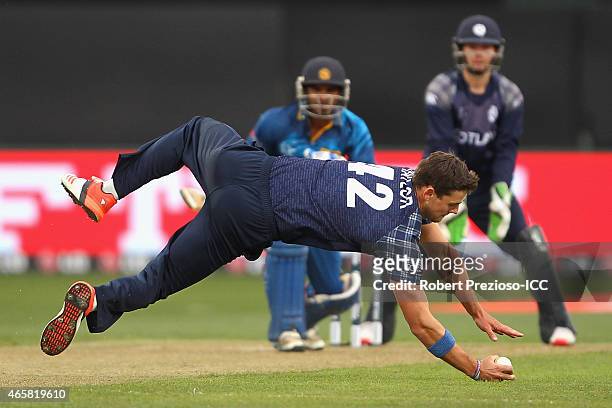 Rob Taylor of Scotland fields the ball off his own bowling during the 2015 Cricket World Cup match between Sri Lanka and Scotland at Bellerive Oval...