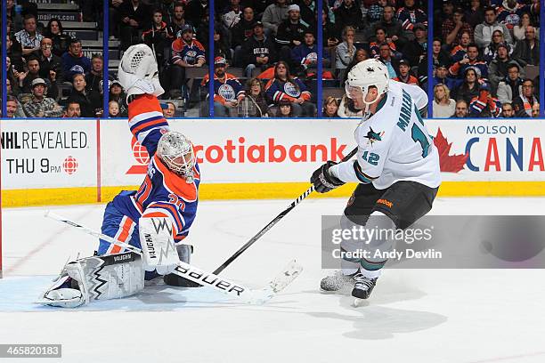 Ben Scrivens of the Edmonton Oilers makes a save on a shot from Patrick Marleau of the San Jose Sharks on January 29, 2014 at Rexall Place in...